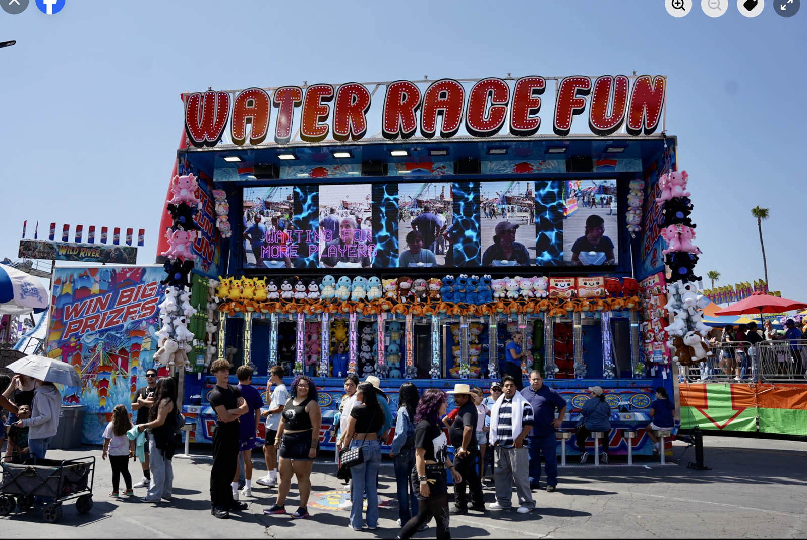 Players competing in water gun race at the midway