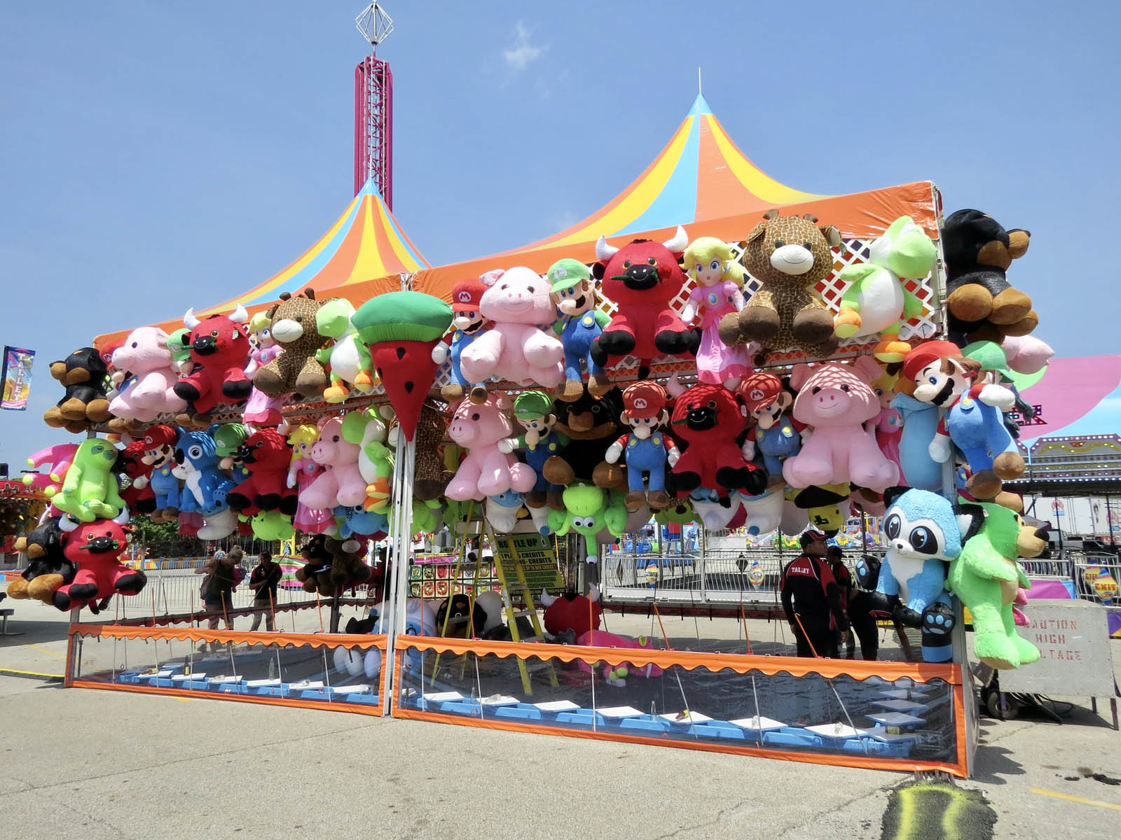 Plush prizes displayed at Bottle Up carnival stand