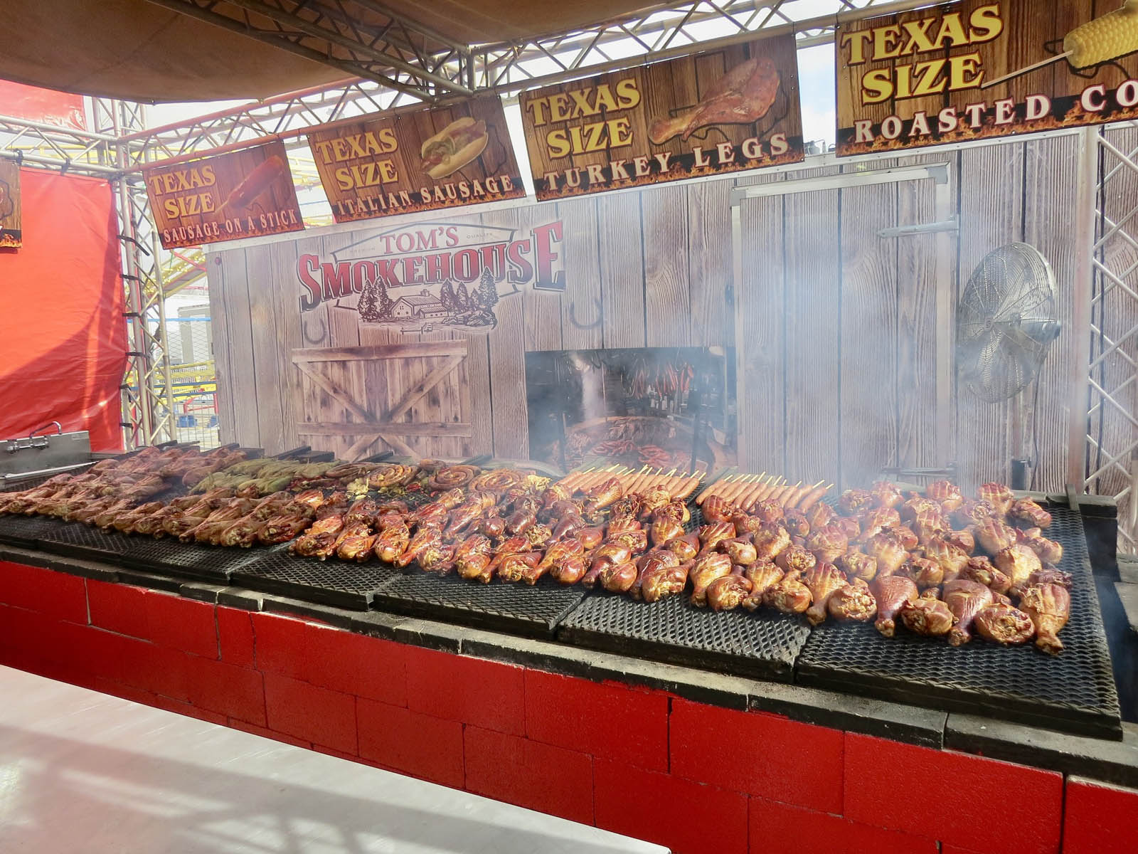 Fifteen-foot Monster Pit smoker cooking barbecue at carnival