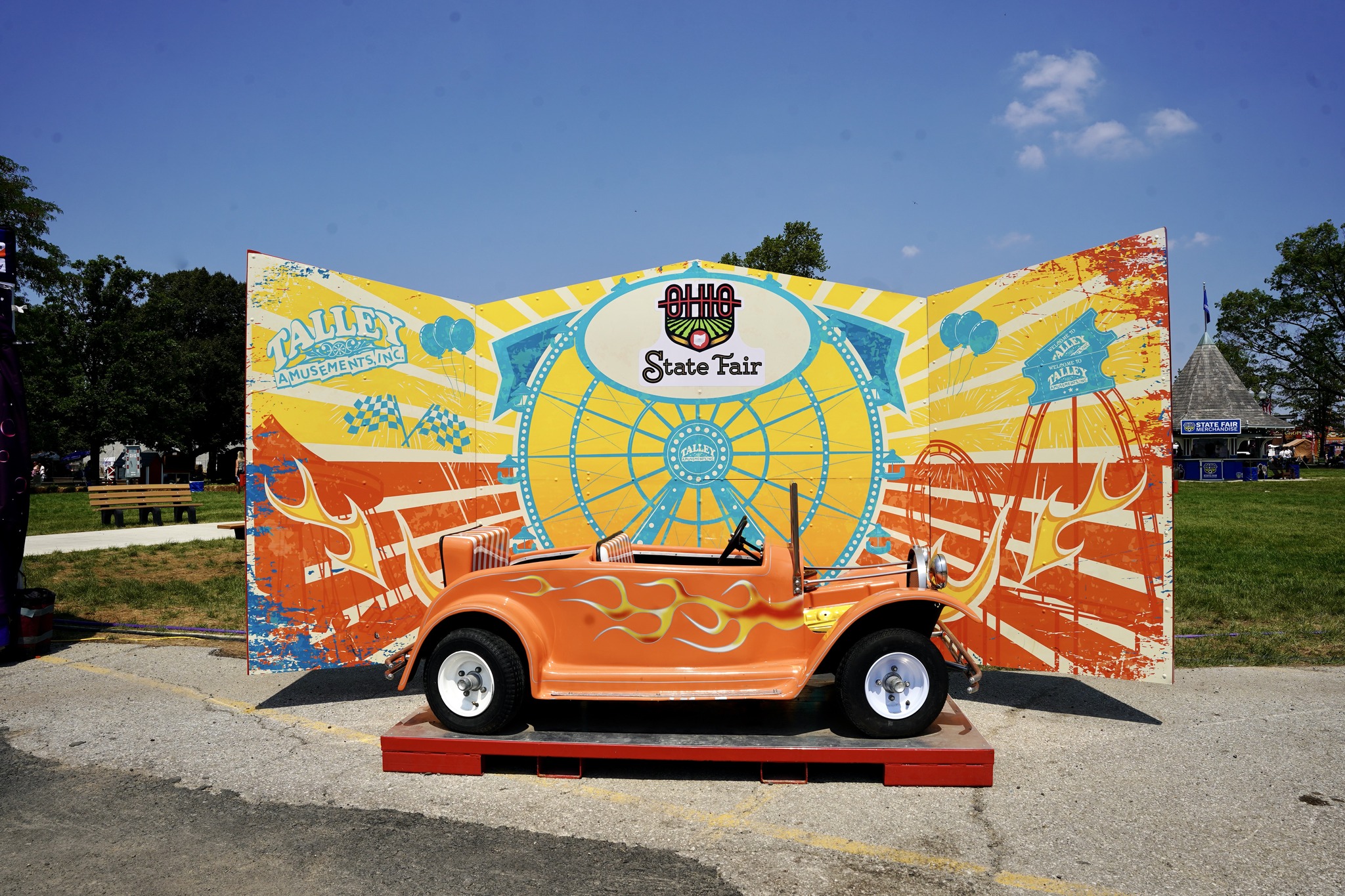 Every midway gets its own decorations with Talley Amusements; this shows a child-sized hot rod on a stand, perfect for photos
